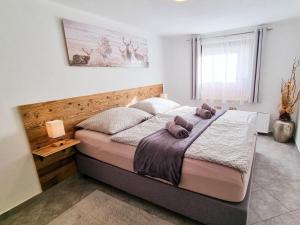 a bedroom with a bed with two pillows on it at Am Inn Fluss in Langkampfen