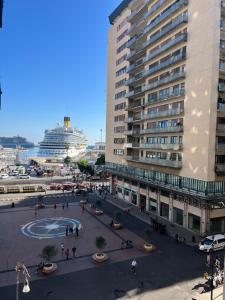 a city with a large building and a cruise ship at Porta Amari B&B in Palermo