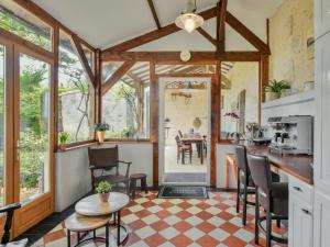 a kitchen and living room with a table and chairs at Lusignac Maswari in Lusignac
