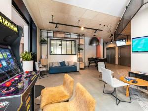 a living room with a video game at ibis Lyon Sud Oullins in Oullins