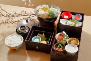 a table topped with three boxes filled with different types of food at Morinoryotei Biei in Biei