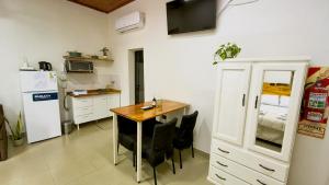 a kitchen with a table and chairs and a refrigerator at La Cruz Apart in Corrientes