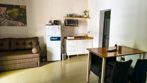a living room with a couch a table and a refrigerator at La Cruz Apart in Corrientes +10 photos
