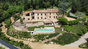 an aerial view of a house with a swimming pool at Masia de Can Roig in Riells