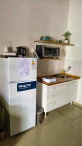a kitchen with a refrigerator and a microwave at La Cruz Apart in Corrientes