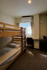 a room with two bunk beds and a desk at HAOSTAY Eirin in Fujikawaguchiko