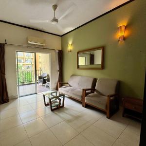 a living room with a couch and a table at Gold Coast Morib Apartment in Banting