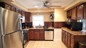 a kitchen with wooden cabinets and a stainless steel refrigerator at 409 Princeton in Cape May Point