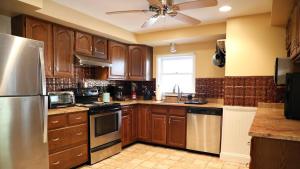 a kitchen with wooden cabinets and a stainless steel refrigerator at 409 Princeton in Cape May Point