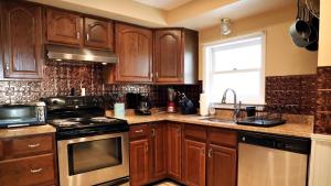 a kitchen with wooden cabinets and a stove top oven at 409 Princeton in Cape May Point +19 photos