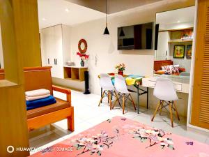 a kitchen and living room with a table and chairs at Suntrust88 Tower1-Unit 4Y in Baguio