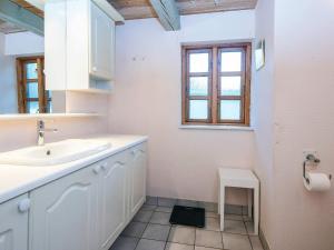 a white bathroom with a sink and a window at House with beautiful garden in Glesborg +45 photos