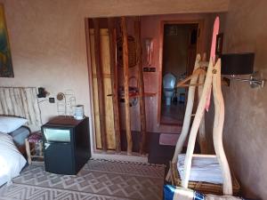 a room with surfboards on the wall and a bed at Trésors des Ancêtres in Ibrahene