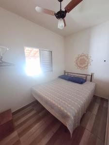 a bedroom with a bed and a ceiling fan at Chácara Florida Boituva in Boituva +31 photos