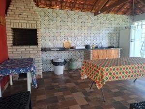 a kitchen with two tables in a room at Chácara Florida Boituva in Boituva