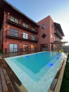 a large swimming pool in front of a building at Ap 101 concept BobZ in Barrinha +11 photos