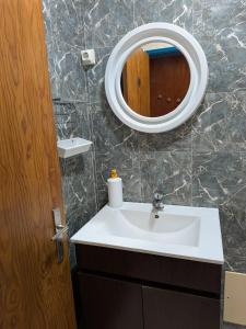 a bathroom with a sink and a mirror at Herdade da Hera in Azambuja