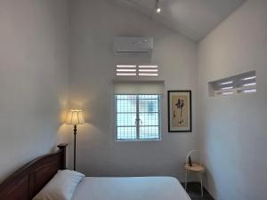 a bedroom with a bed and a window at Zen 1 Room KL in Kuala Lumpur