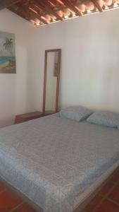 a bedroom with a bed in a room at Casa bela vista in Icapuí