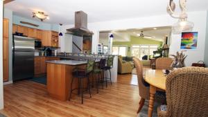a kitchen and living room with a table and chairs at The Roost Ii On Leaming in West Cape May
