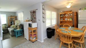 a kitchen and living room with a table and chairs at 12 Mechanic St in West Cape May