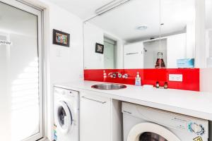 a laundry room with a sink and a washing machine at A AAA Coke Shack in Point Lookout