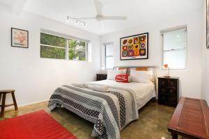 a white bedroom with a bed and two windows at A AAA Coke Shack in Point Lookout
