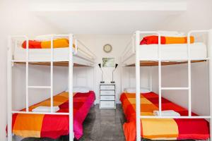 a bedroom with two bunk beds and a desk at A AAA Coke Shack in Point Lookout