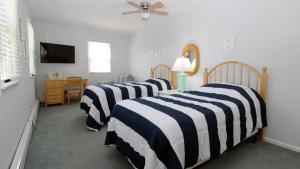 a bedroom with two beds with black and white stripes at Life S A Beach in Cape May