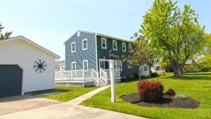 a blue house with a garage and a driveway at Life S A Beach in Cape May