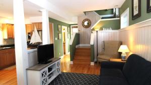a living room with a couch and a tv at Gray Cottage On Windsor in Cape May +11 photos