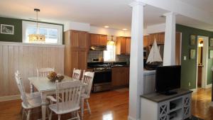 a kitchen and dining room with a table and chairs at Gray Cottage On Windsor in Cape May