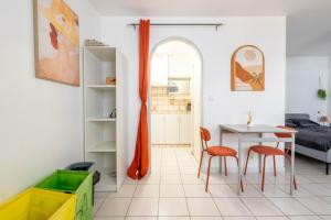 a room with a table and two chairs and a bedroom at Cocon Studio proche Disneyland in Lagny +17 photos