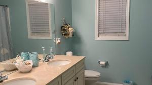 a bathroom with two sinks and a toilet at 717 Broadway in West Cape May