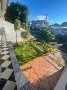 a view from the balcony of a house with palm trees at Lareconexao in Foz do Iguaçu +9 photos