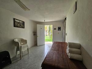 a room with a couch and a table and a chair at Alojamiento en las Huertas in Barrio Nuevo