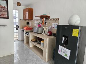 a kitchen with a black refrigerator in a room at Alojamiento en las Huertas in Barrio Nuevo