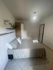 a bedroom with a large bed with two pillows at Lareconexao in Foz do Iguaçu
