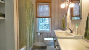 a bathroom with a toilet and a sink and a window at 639 Seagrove in Cape May Point