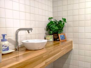 a white bowl sink on a wooden counter in a bathroom at Blu Mare in Ō-shima +28 photos