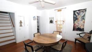 a dining room with a wooden table and chairs at The Elmira Escape in Cape May