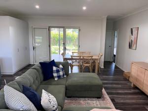 a living room with a couch and a table at Hathaway House in Toowoomba