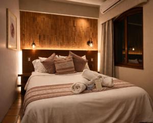 a hotel room with a bed with towels on it at Hotel Boutique Casa Gopar in Ocotlán de Morelos