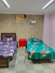 a bedroom with two beds and a fan at WISHTREE CORPORATE MENS only DORMITORY FOR TECHIES AND Trainees in Chennai
