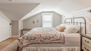 a bedroom with a bed with a blanket on it at Little Cottage On Lafayette in Cape May