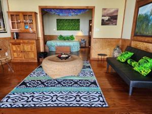 a living room with a couch and a table at Le Vasa Resort in Fuailalo