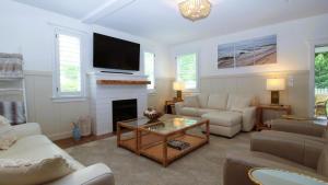 a living room with a couch and a fireplace at Beach Croft in West Cape May