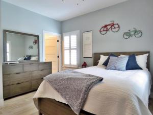 a bedroom with a bed with a mirror and two bikes on the wall at The Sunrise On Sunset in West Cape May