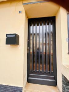 a black door with a metal gate on a building at Chambre à soulac in Soulac-sur-Mer