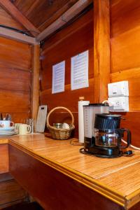 a counter with a coffee maker on top of it at Cabañas SyC in Fortuna